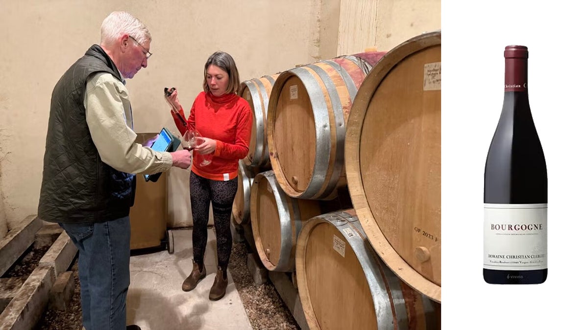 Tasting in the Clerget cellar beside barrels, with a bottle of Clerget Bourgogne Rouge.